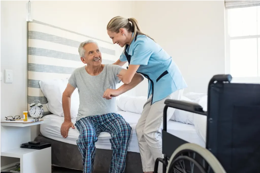 Nurse helping patient get out of bed